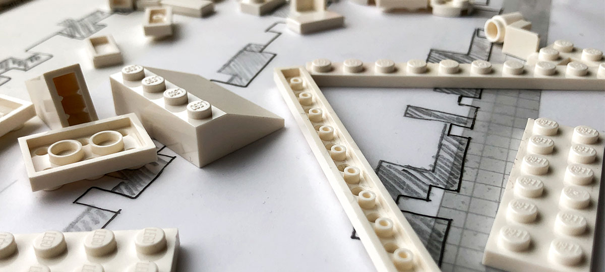 Lego white scattered on a construction scheme