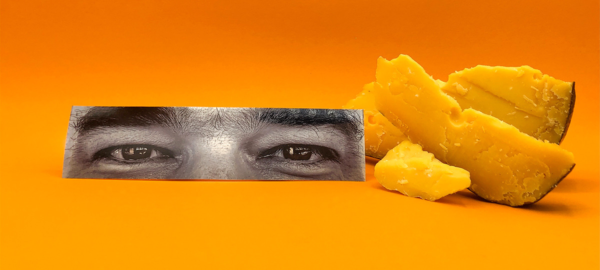 Picture of Raphaël Chauvet’s eyes associated with cheese on an orange background for the Bulle Architectes agency in Bordeaux.