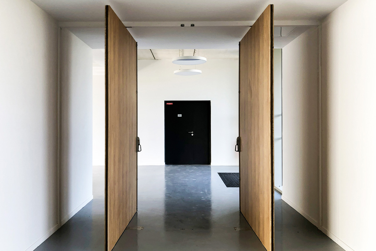 View of the passage between the reception and the reception room of the village hall of Montpouillan realized by the Bordeaux agency Bulle Architects.